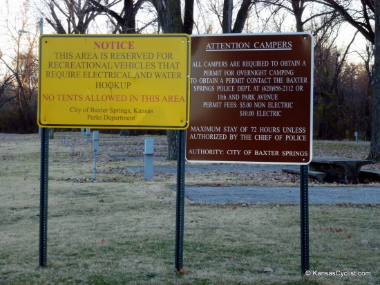 Baxter Springs Riverside Park - Rules - This sign in the RV area of Baxter Springs Riverside Park specifies that all campers must obtain a permit for overnight camping from the Baxter Springs police department.