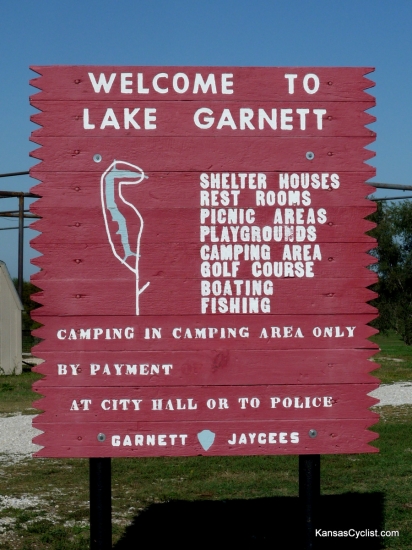 Garnett North Lake Park - Sign - This is the entrance sign to North Lake Park in Garnett, Kansas. It lists the facilities at the lake, and specifies that camping is permitted in the camping area only. It also says that payment can be made at city hall or the police station. There is also a self-pay station at the campground. Garnett North Lake Park - Sign - This is the entrance sign to North Lake Park in Garnett, Kansas. It lists the facilities at the lake, and specifies that camping is permitted in the camping area only. It also says that payment can be made at city hall or the police station. There is also a self-pay station at the campground.