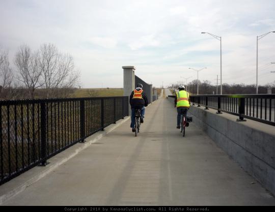 Bicyclists in Olathe, Kansas - Bicyclists on a sidepath along 111th Street, cross a bridge over the Mill Creek Streamway, in Olathe, Kansas.