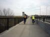Bicyclists in Olathe, Kansas - Bicyclists on a sidepath along 111th Street, cross a bridge over the Mill Creek Streamway, in Olathe, Kansas.
