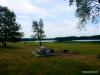 Louisburg Middle Creek State Fishing Lake - Campsite - A typical campsite at Louisburg Middle Creek State Fishing Lake, with a fire ring, picnic tables, grass, and some shade trees. There are approximately ten such sites available on the north shore of the lake.