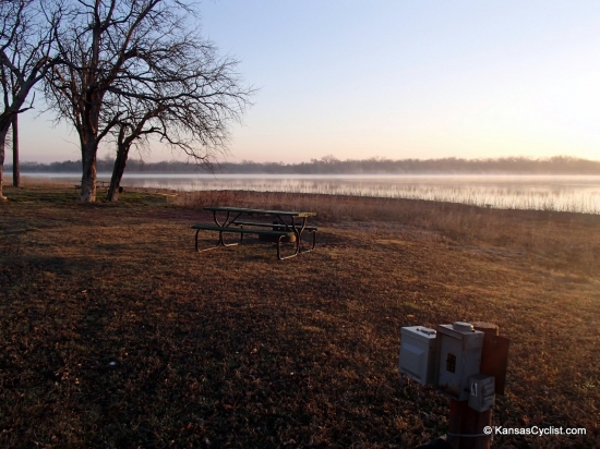Santa Fe Lake - Campsite - This is a typical campsite at Santa Fe Lake, with a picnic table, fire ring, electricity, and grass for tenting. There are nearby portable toilets.