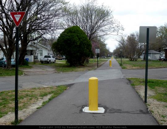 Watco Trail in Pittsburg, Kansas - Watco Trail runs diagonal to the street grid, so there are over 20 road crossings along the route, each one with bollards and signs. Yield to any on-street traffic.