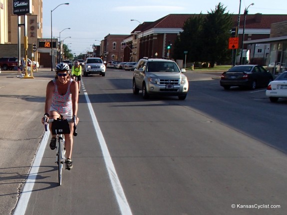 Cyclists riding the new Hays bike lanes.