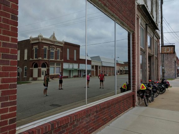 A rowdy crew of touring cyclists on busy Main Street in Waverly, Kansas.