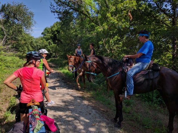 Bicyclists and equestrians on the Flint Hills Nature Trail near Rantoul. With mutual respect and care, it's easy to share the trail!