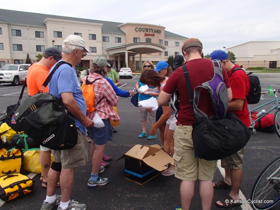 Riders gather in Junction City to check in, load their bikes on the gear truck, and hop a bus to Hays.